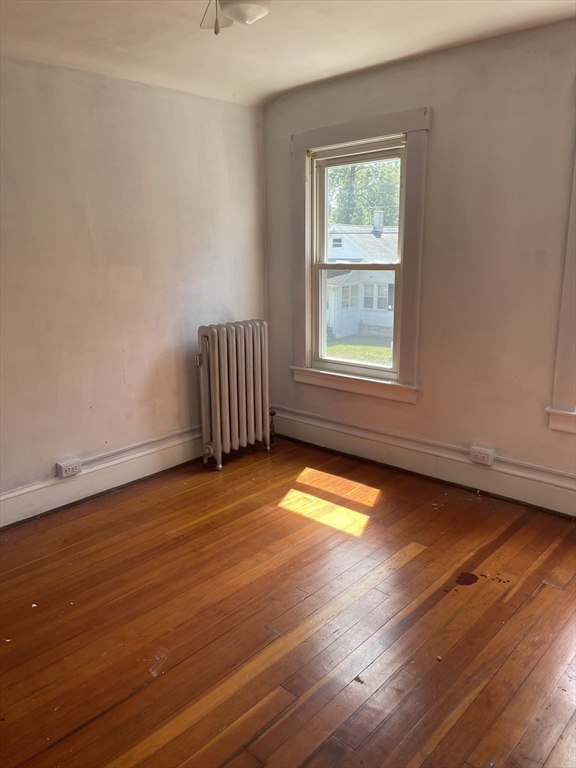 245 Arthur Street Springfield, MA 01104 - Photo 17 of 20 an empty room with wooden floor and windows