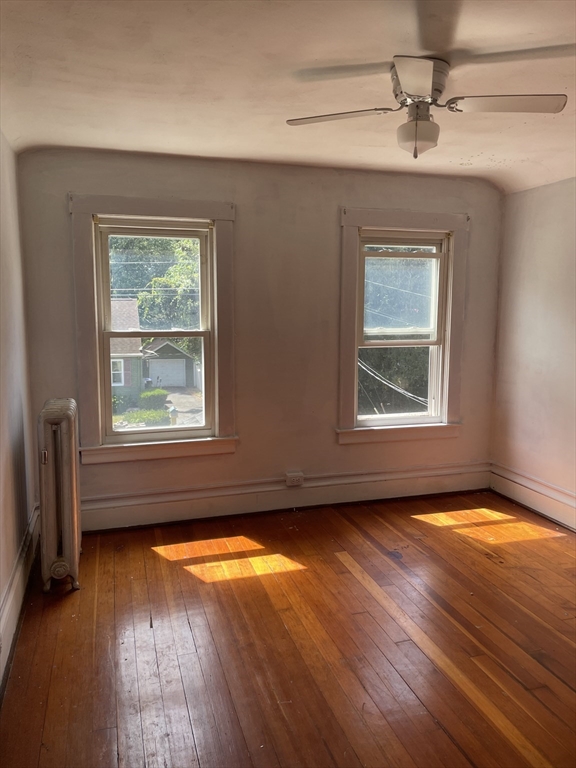 245 Arthur Street Springfield, MA 01104 - Photo 18 of 20 an empty room with wooden floor and windows