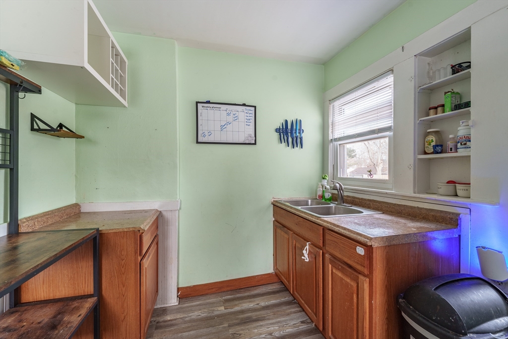 245 Arthur Street Springfield, MA 01104 - Photo 5 of 20 a kitchen with a sink stove and wooden cabinets