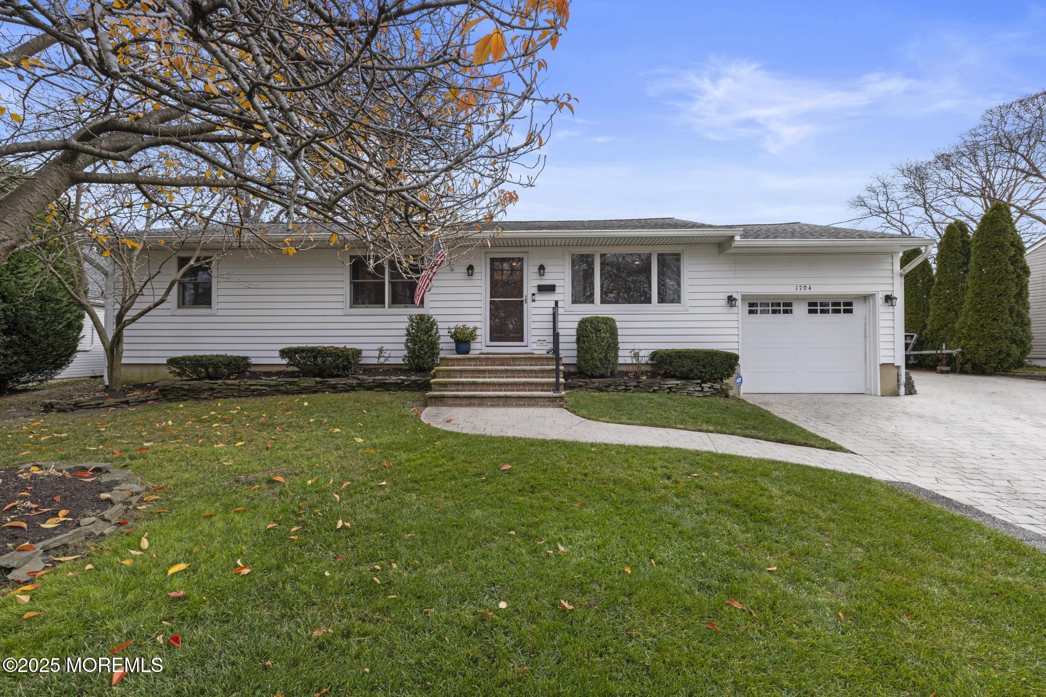 1704 Grove Street Wall, NJ 07719 - Photo 1 of 53 a house view with a sitting space and garden