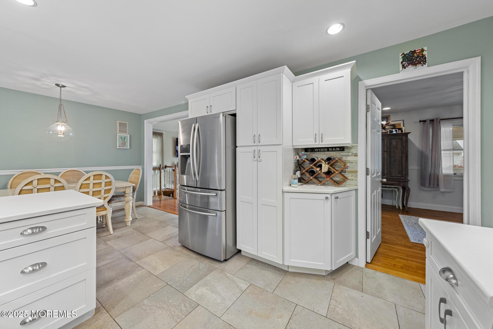 1704 Grove Street Wall, NJ 07719 - Photo 11 of 53 a kitchen with a refrigerator a stove top oven and cabinets