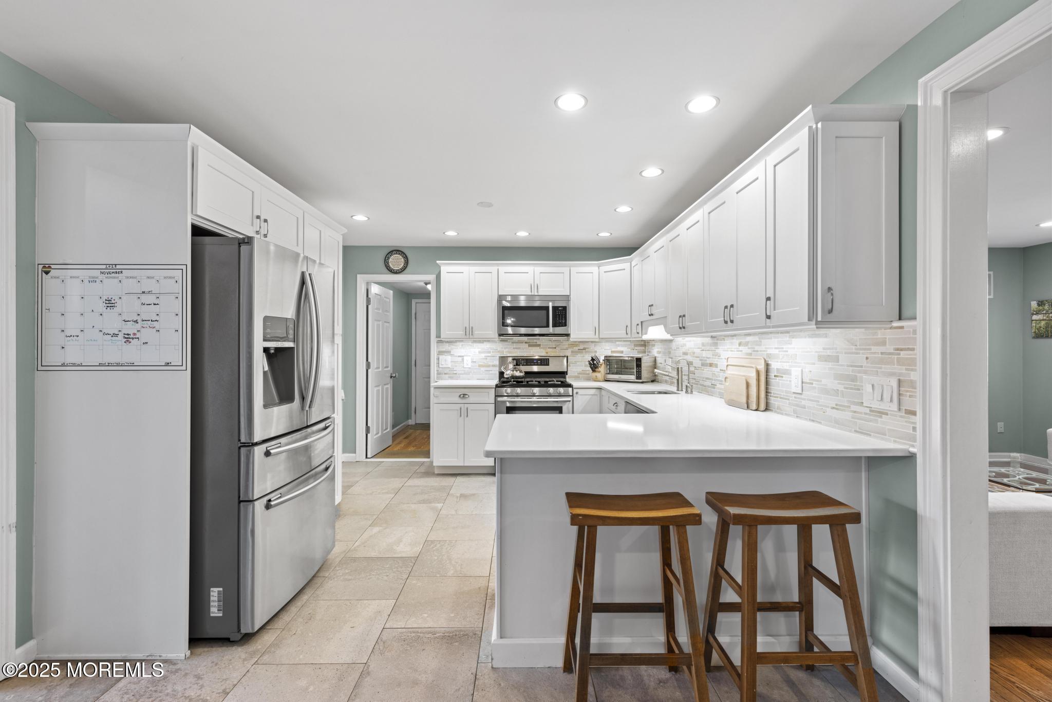 1704 Grove Street Wall, NJ 07719 - Photo 12 of 53 a kitchen with stainless steel appliances granite countertop a refrigerator and a stove top oven