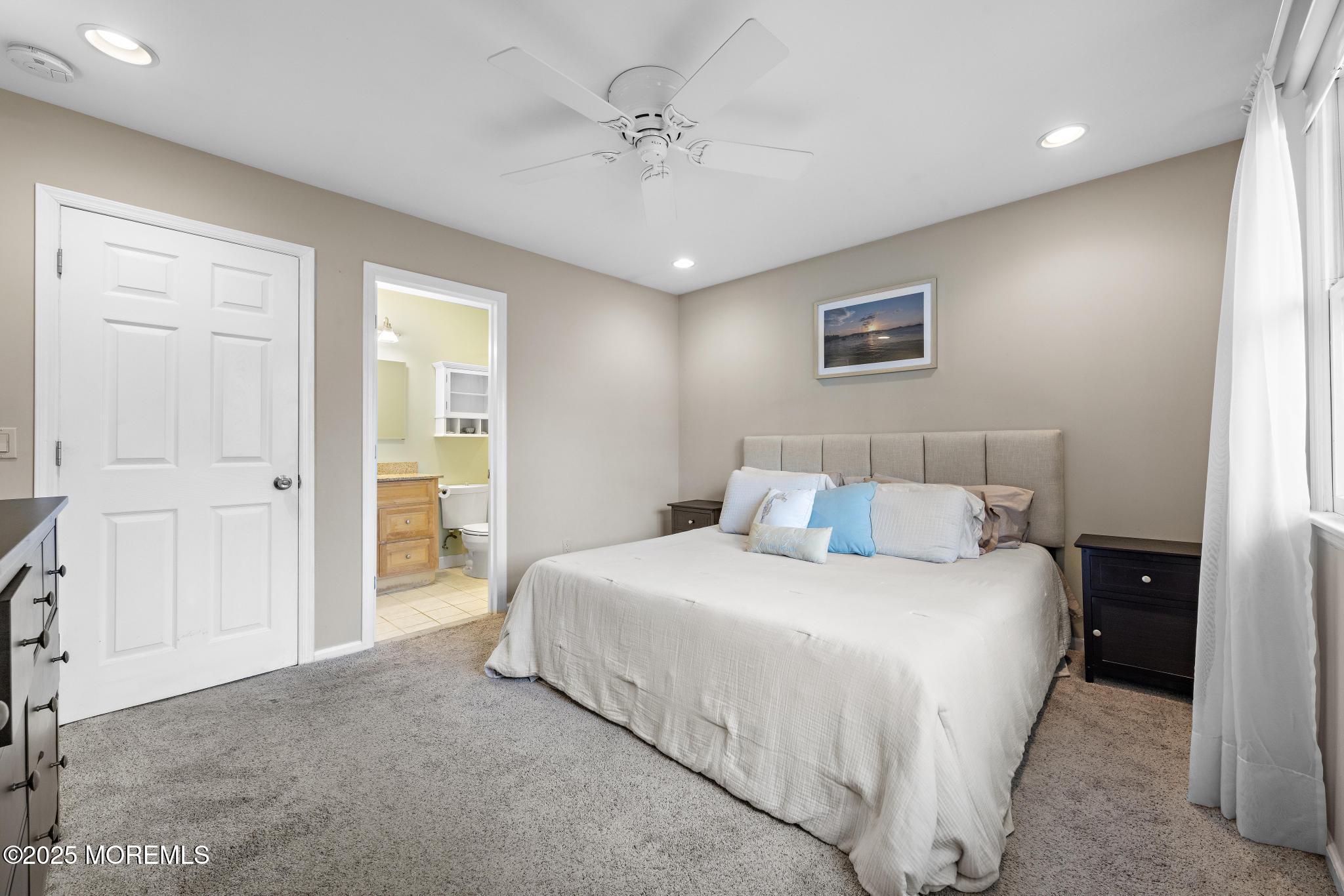 1704 Grove Street Wall, NJ 07719 - Photo 25 of 53 a bedroom with a bed and a chandelier