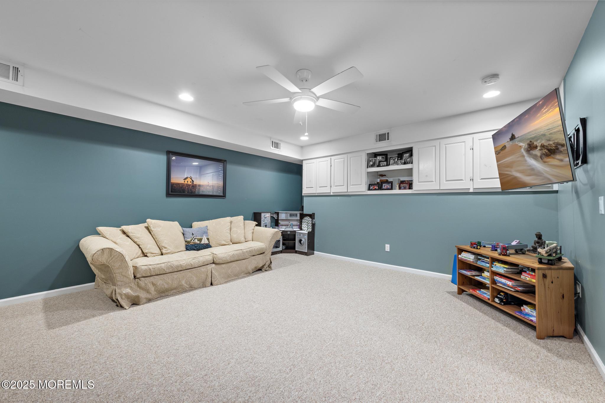 1704 Grove Street Wall, NJ 07719 - Photo 31 of 53 a living room with furniture and a ceiling fan