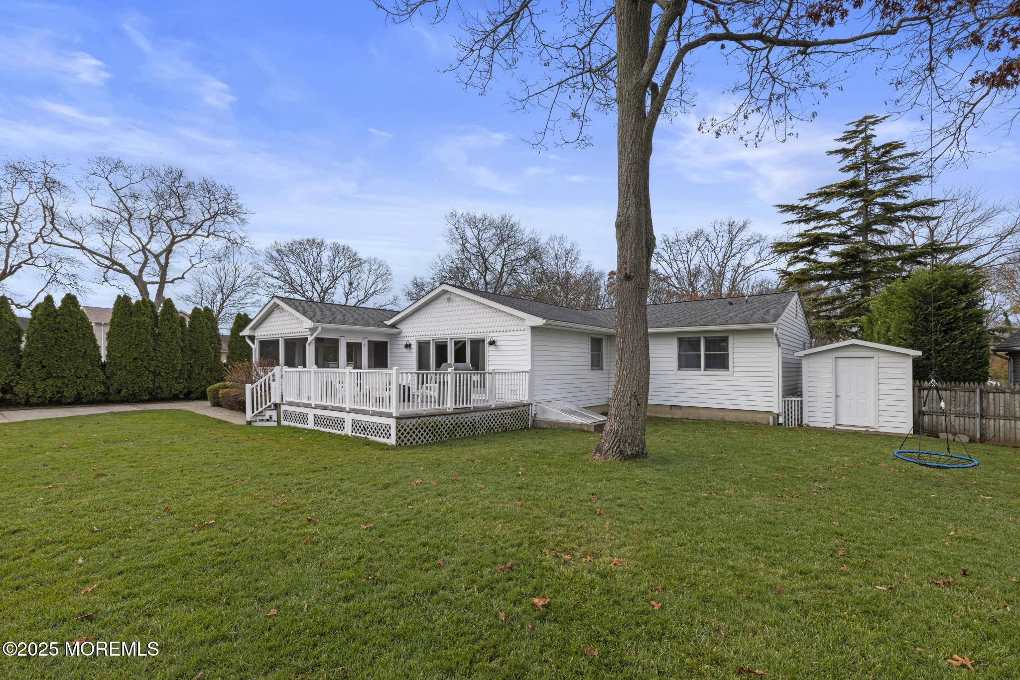 1704 Grove Street Wall, NJ 07719 - Photo 44 of 53 a white house with a big yard and large trees