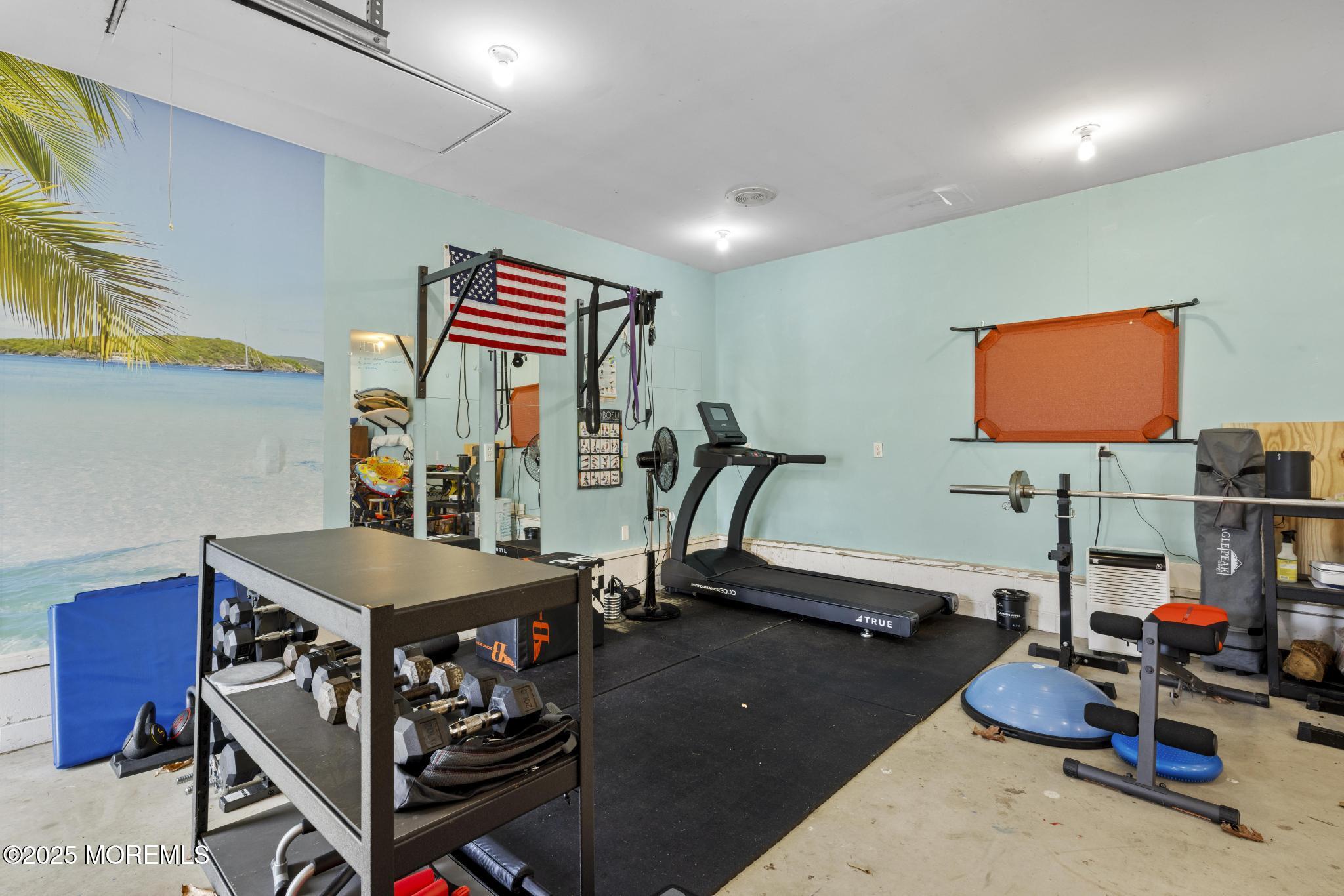 1704 Grove Street Wall, NJ 07719 - Photo 47 of 53 a room with gym equipment and a flat screen tv
