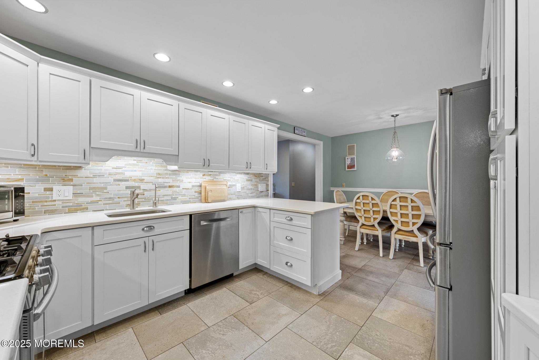 1704 Grove Street Wall, NJ 07719 - Photo 10 of 53 a kitchen with cabinets and chairs