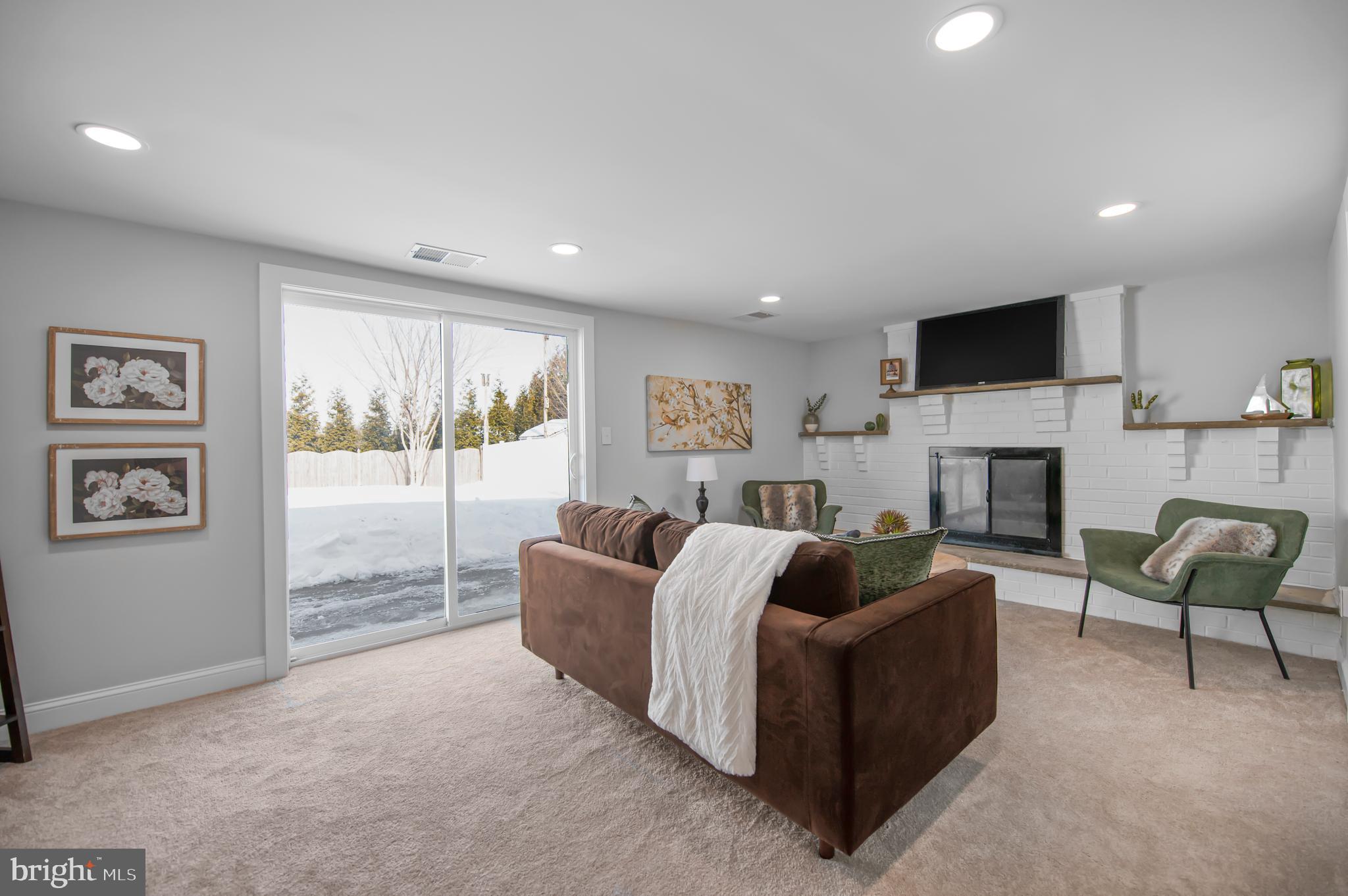 356 Abrams Mill Road King of Prussia, PA 19406 - Photo 22 of 46 a living room with furniture a flat screen tv and a fireplace