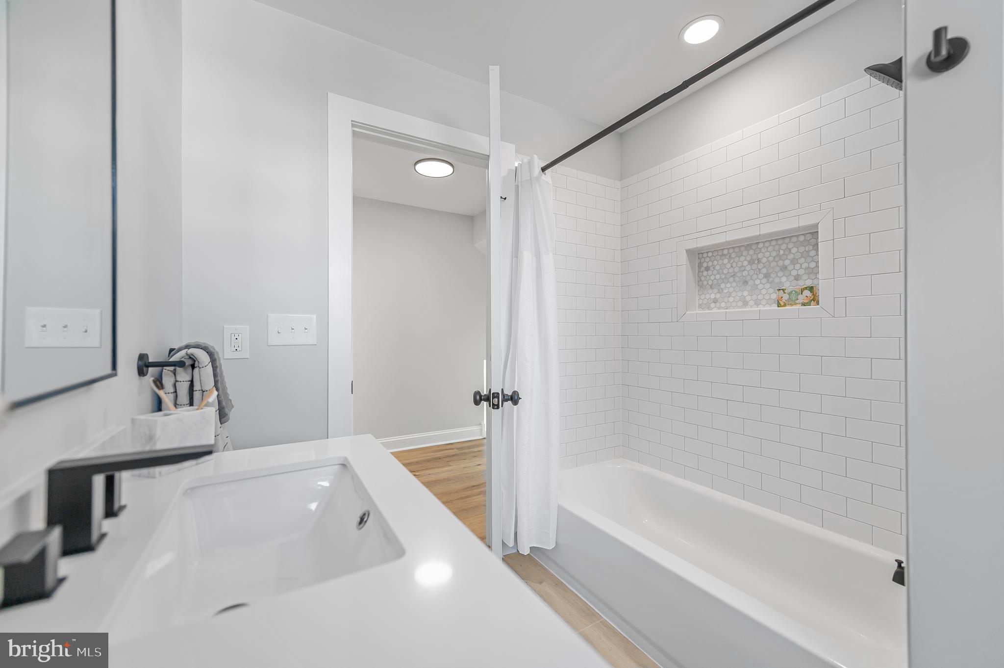 356 Abrams Mill Road King of Prussia, PA 19406 - Photo 38 of 46 a bathroom with a tub a sink and a large mirror