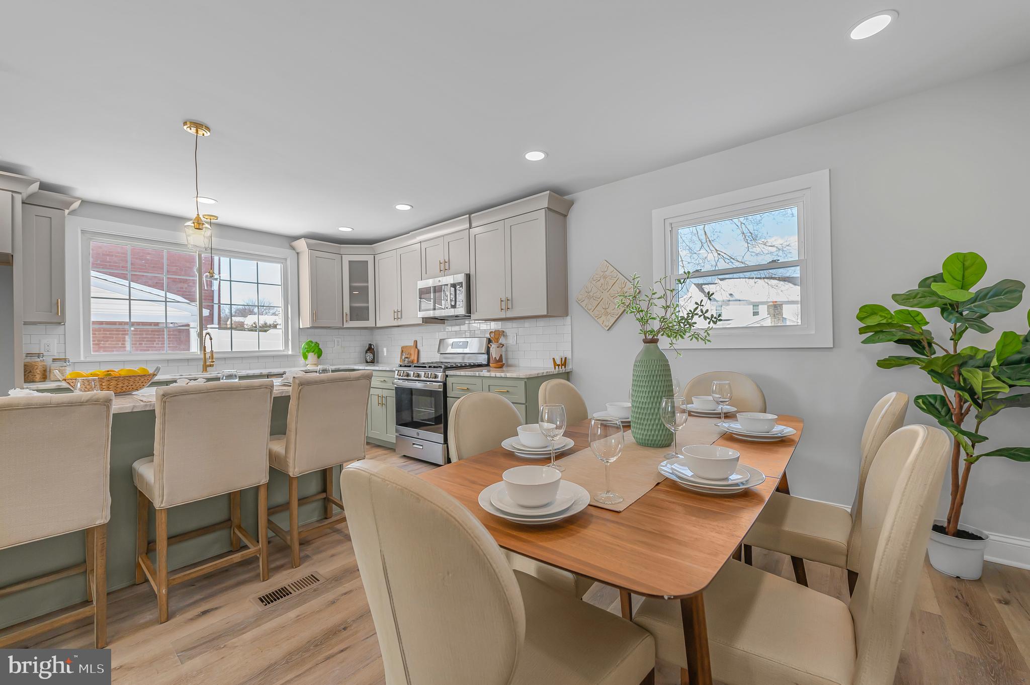 356 Abrams Mill Road King of Prussia, PA 19406 - Photo 9 of 46 a dining room with furniture a potted plant and a kitchen view