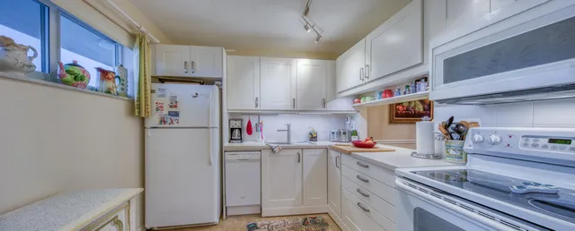 a kitchen with refrigerator and cabinets