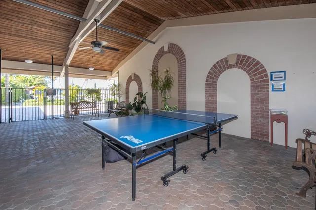 a view of a patio with table and chairs potted plants