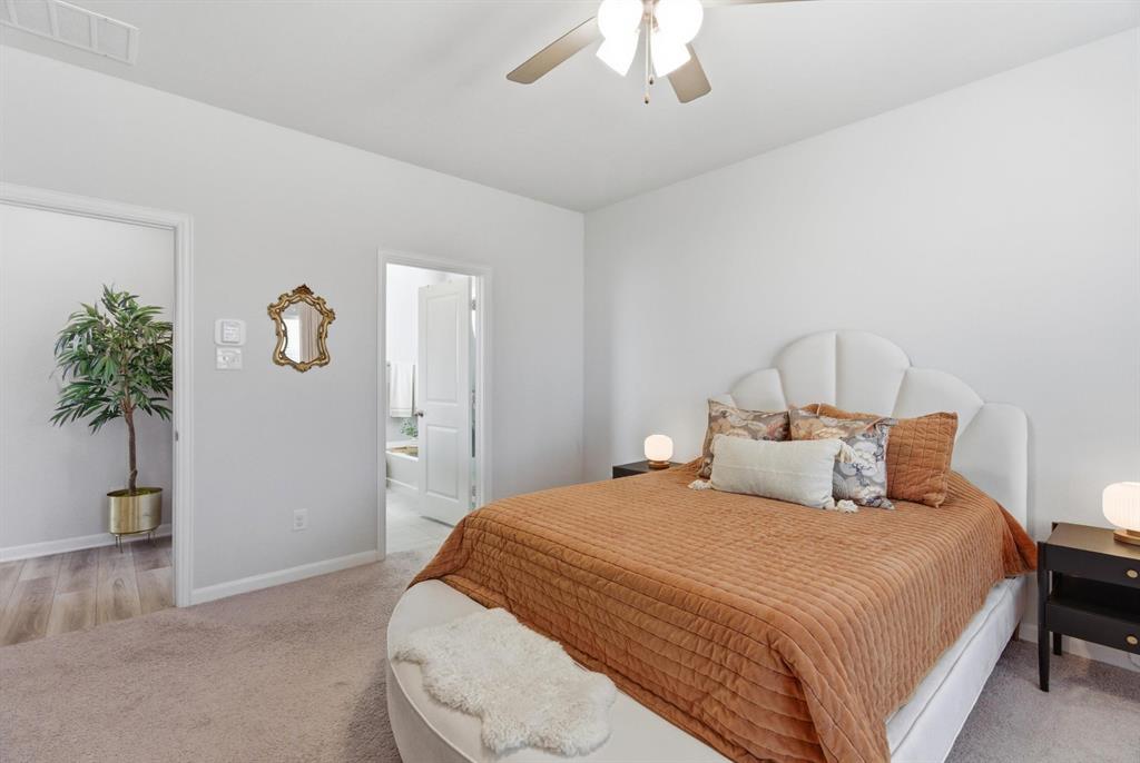 2002 Bronte Dr. Forney, TX 75126 - Photo 12 of 34 a bedroom with a bed and a potted plant