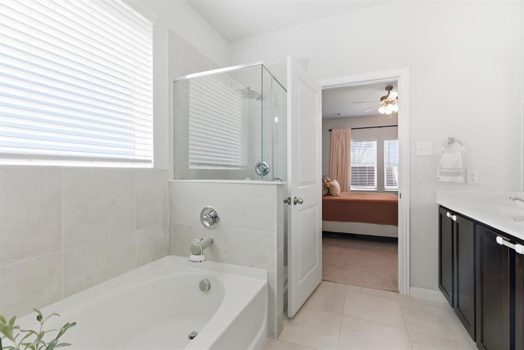 2002 Bronte Dr. Forney, TX 75126 - Photo 14 of 34 a bathroom with a tub a sink and a window