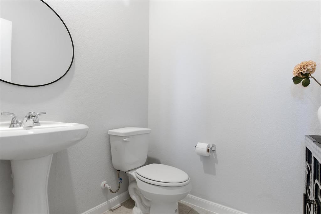 2002 Bronte Dr. Forney, TX 75126 - Photo 18 of 34 a bathroom with a sink and a toilet
