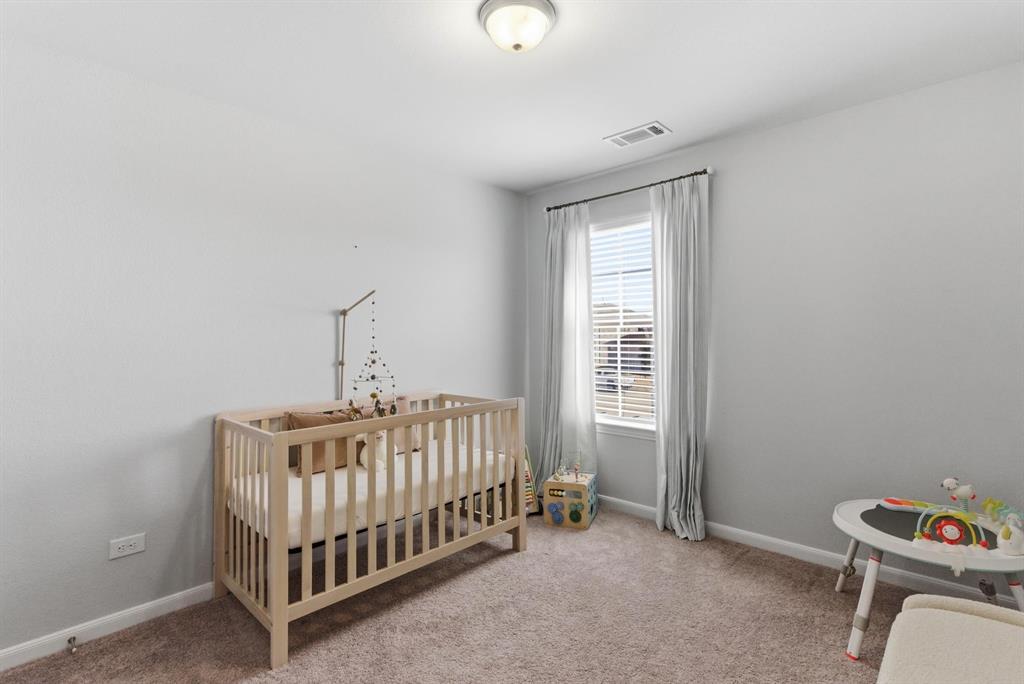 2002 Bronte Dr. Forney, TX 75126 - Photo 28 of 34 a view of a room with baby crib and a window