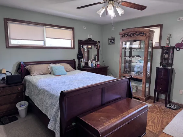 a bedroom with a bed and window