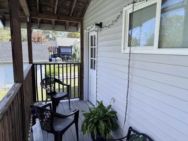 a view of balcony with furniture
