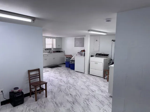 a utility room with cabinets dryer and washer