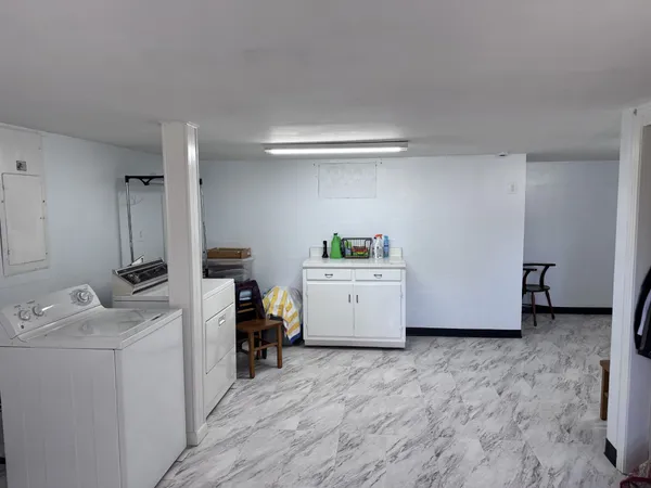 a view of storage and utility room with washer and dryer
