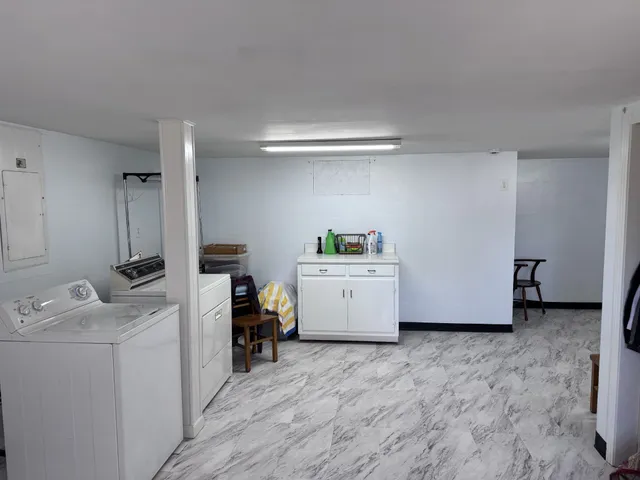 a view of storage and utility room with washer and dryer
