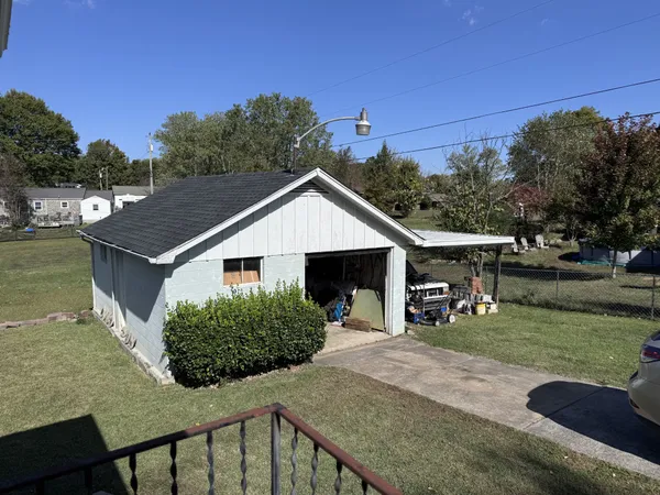 a view of a house with backyard and sitting area