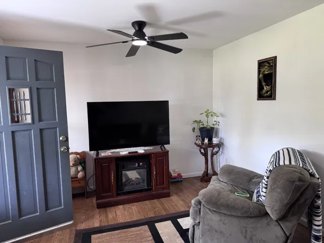 a living room with furniture and a flat screen tv