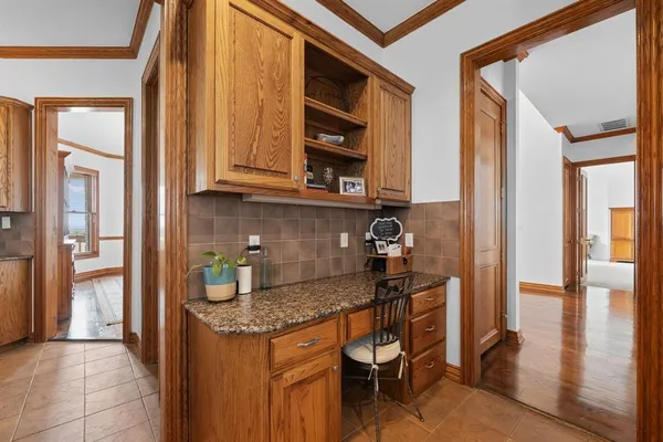 a kitchen with stainless steel appliances granite countertop sink stove top oven and cabinets