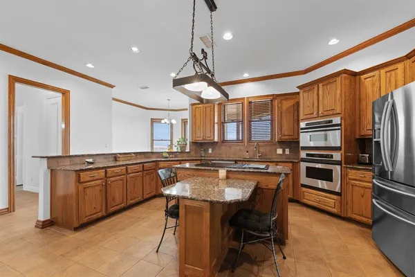 a kitchen with a table and chairs in it