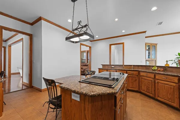 a kitchen with stainless steel appliances granite countertop a sink a stove and refrigerator