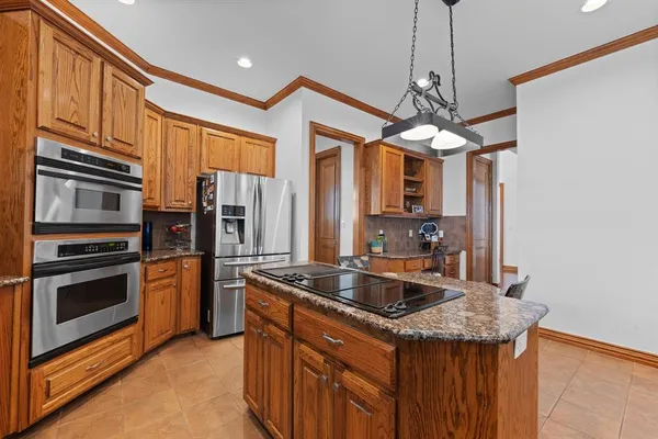 a kitchen with stainless steel appliances granite countertop wooden cabinets a sink and dishwasher