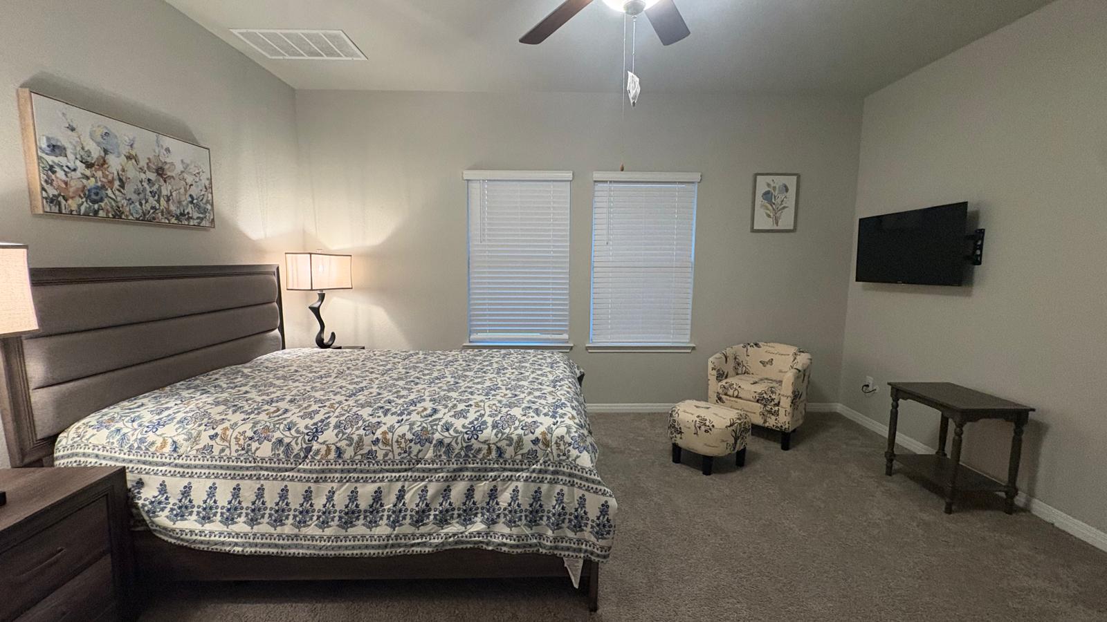 6511 Dragride Road Buda, TX 78610 - Photo 15 of 36 Rest peacefully in this primary bedroom featuring soft carpeting and natural light from the windows.