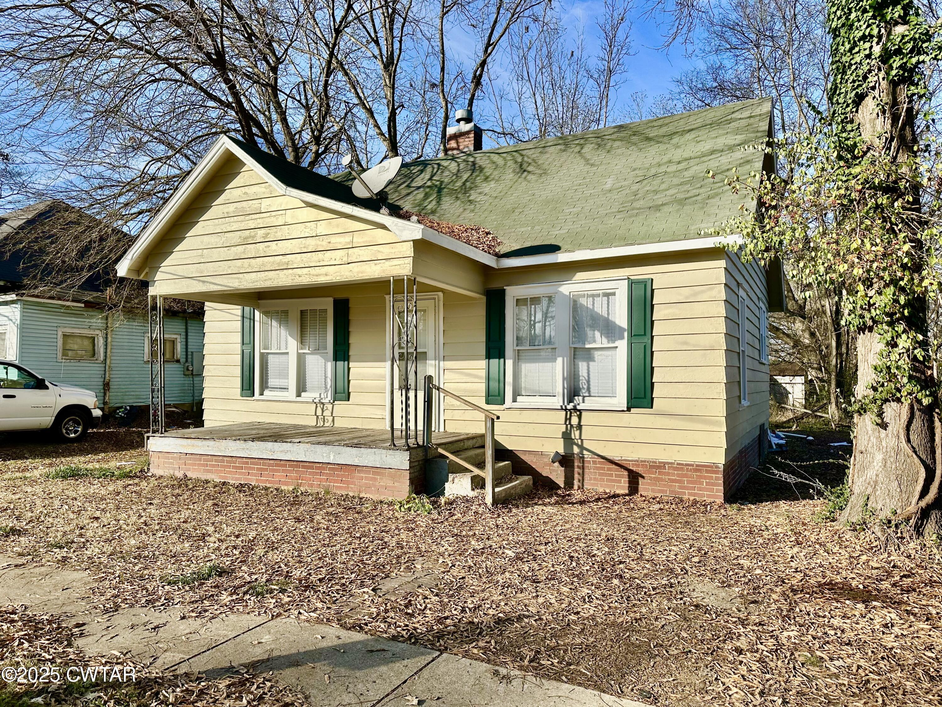 1509 Vine Street Humboldt, TN 38343 - Photo 1 of 9 a view of a house with a patio and a yard