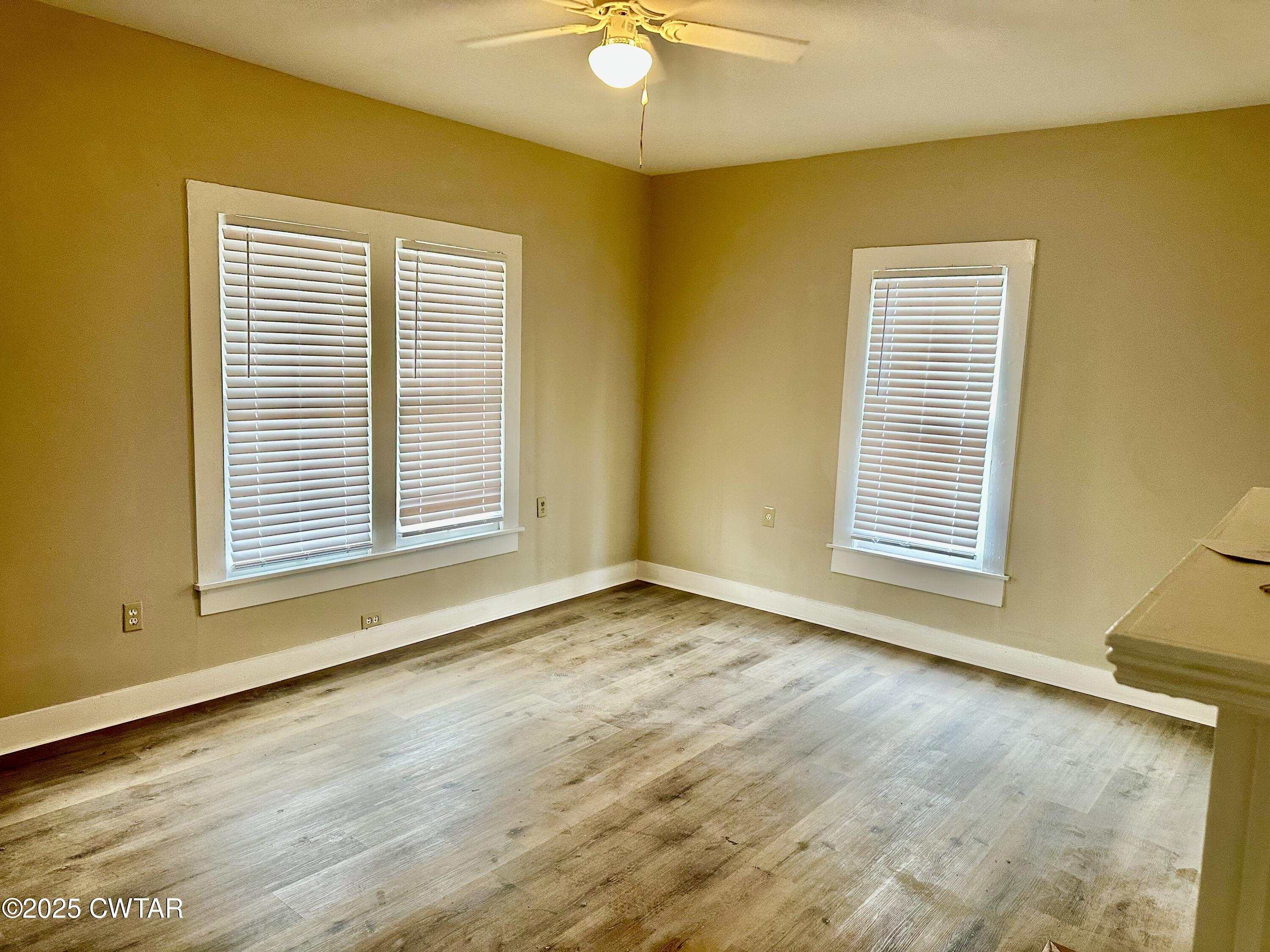 1509 Vine Street Humboldt, TN 38343 - Photo 4 of 9 a view of an empty room with a window and dresser