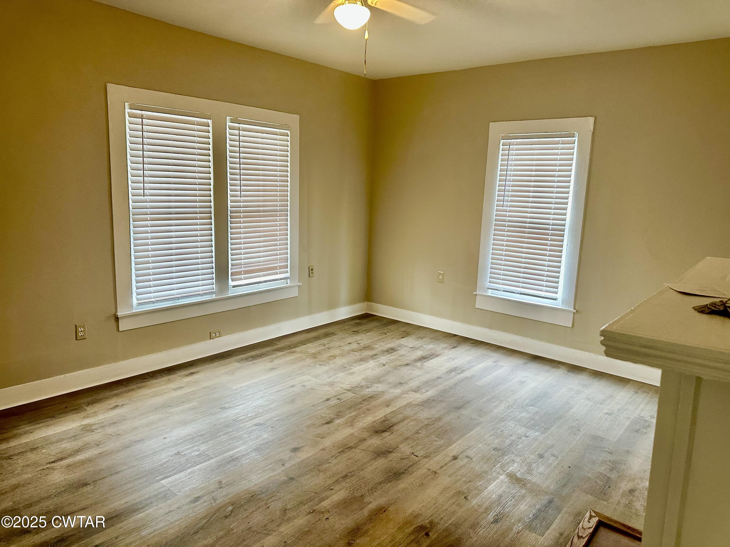 1509 Vine Street Humboldt, TN 38343 - Photo 5 of 9 a view of an empty room with window and wooden floor