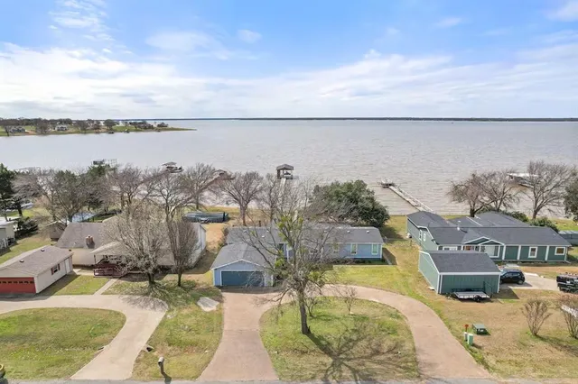 a view of a lake with couches in front of house