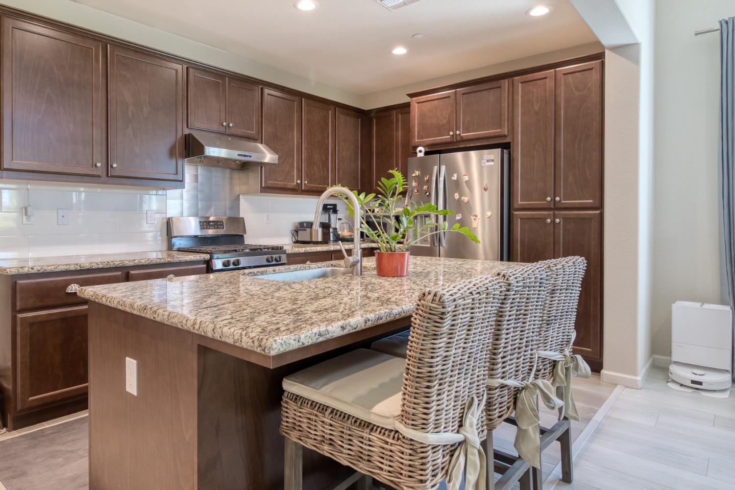 4341 Trailblazer Way Modesto, CA 95356 - Photo 15 of 27 a kitchen with granite countertop a sink cabinets and stainless steel appliances