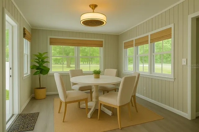 a view of a dining room with furniture and a window