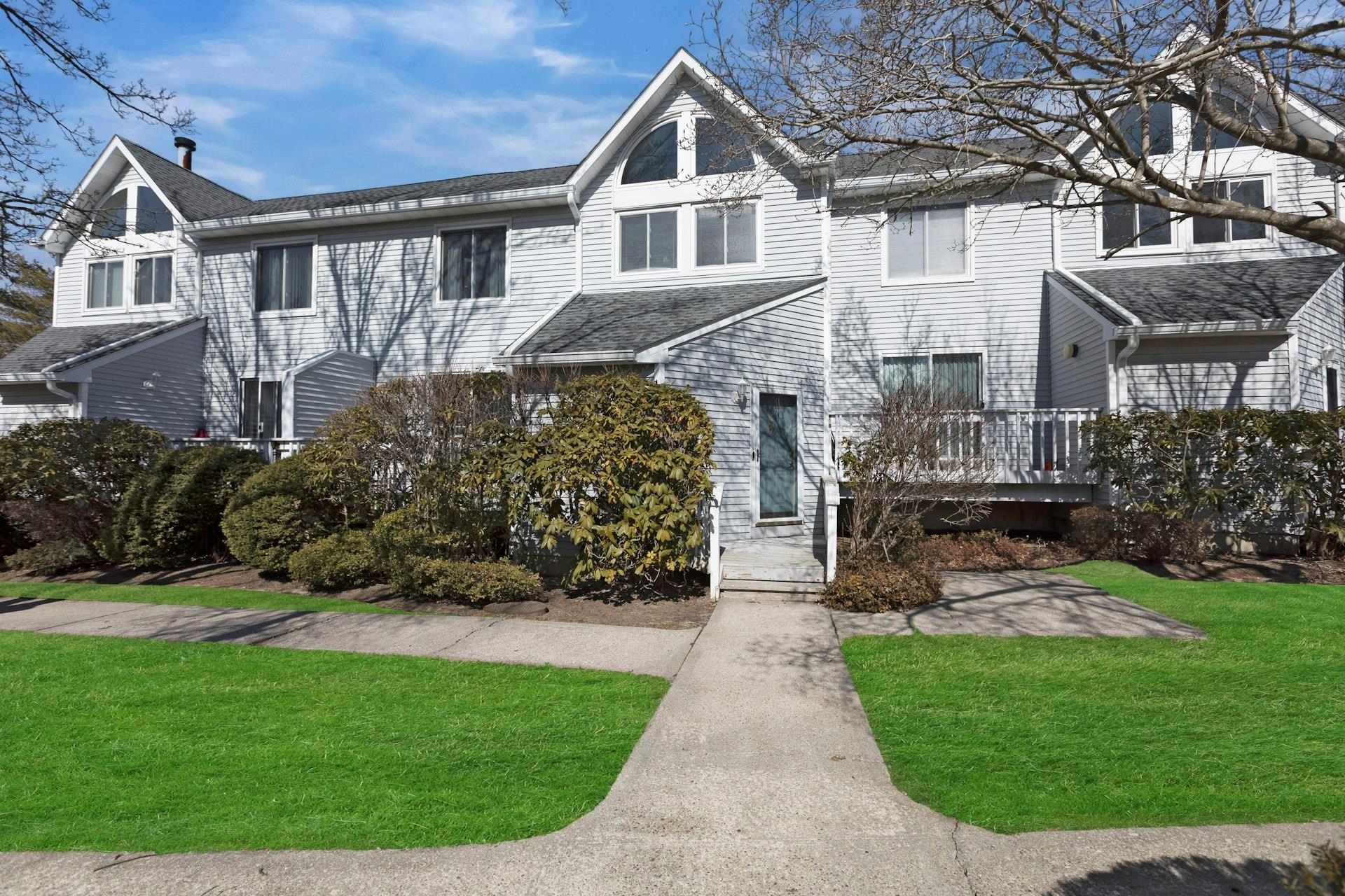 35 Gibbs Road, Unit 7 Coram, NY 11727 - Photo 1 of 1 View of front facade featuring a front lawn