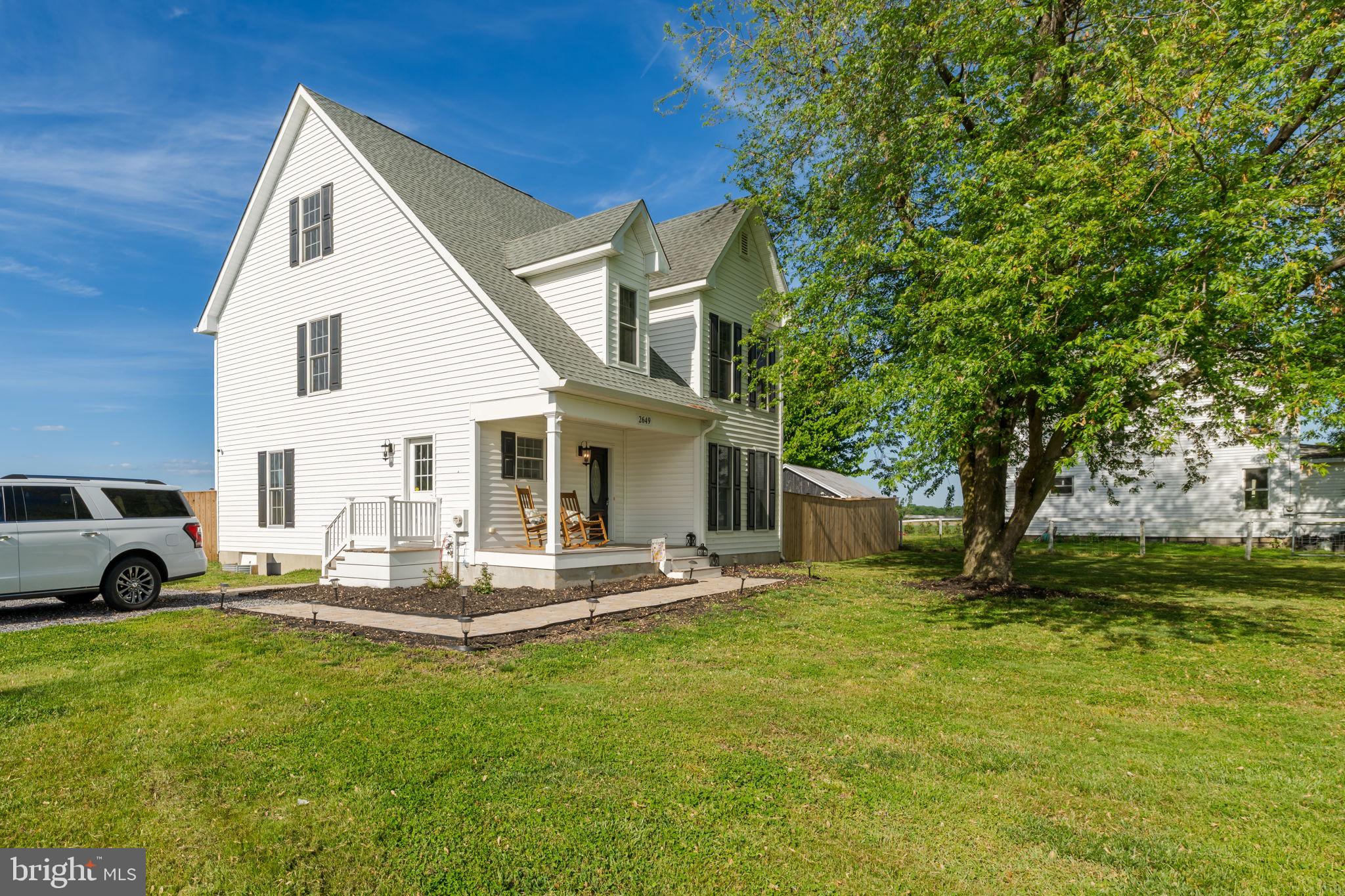 Charming home with lush green surroundings.