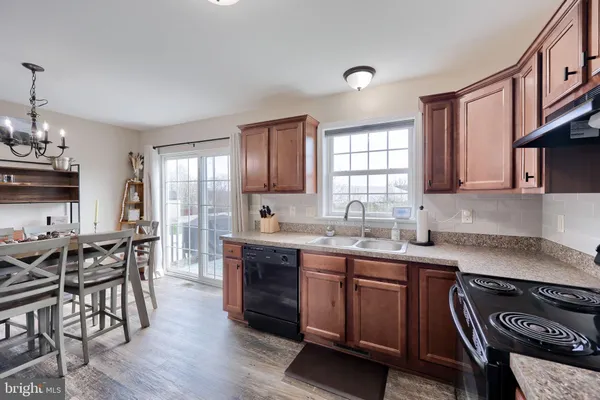 a kitchen with lots of counter top space and dining table chairs
