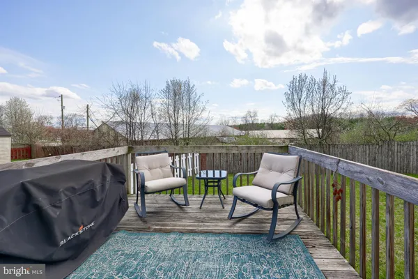 a balcony with couple of chairs and a couch