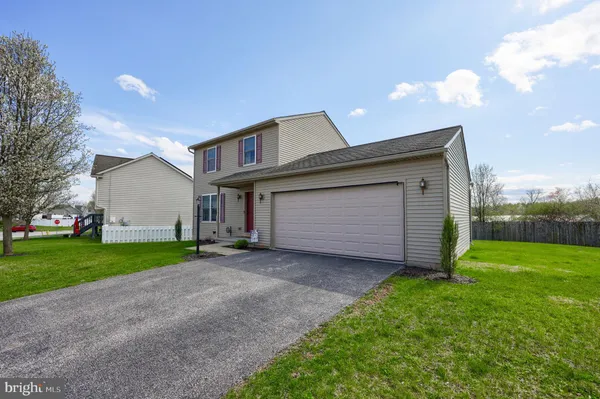 a view of a house with a yard and garage