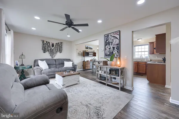 a living room with furniture and a view of kitchen