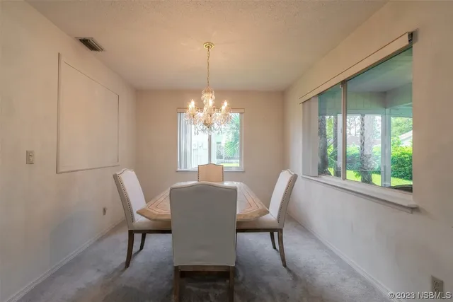 a view of a dining room with furniture window and outside view