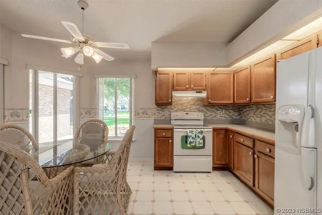 a kitchen with stainless steel appliances granite countertop a stove top oven a sink a counter space and cabinets