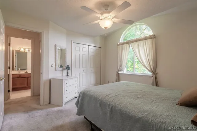 a bedroom with a bed and dresser with mirror