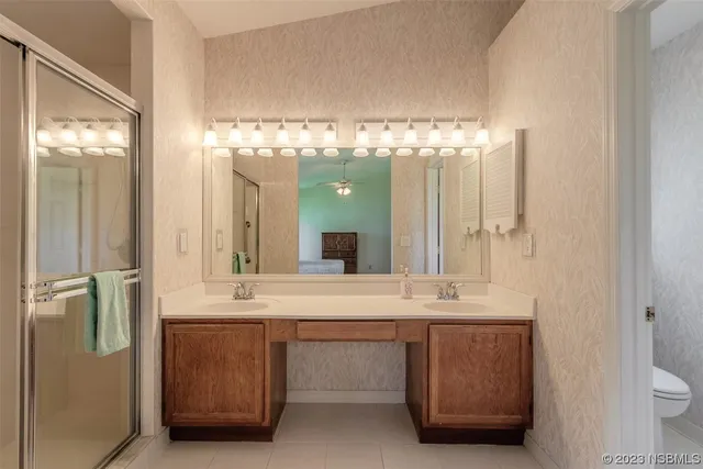 a bathroom with a sink double vanity and a shower