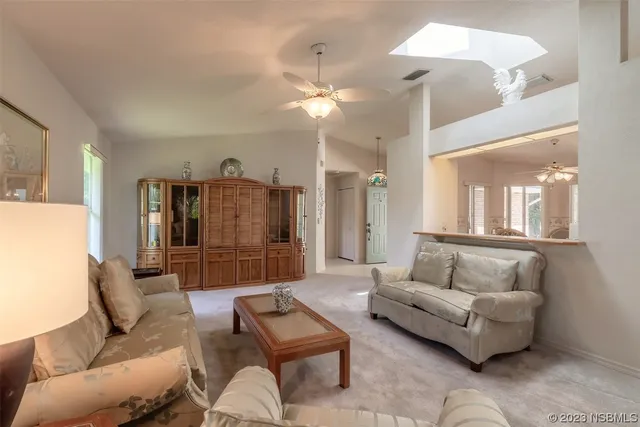 a living room with furniture and a ceiling fan