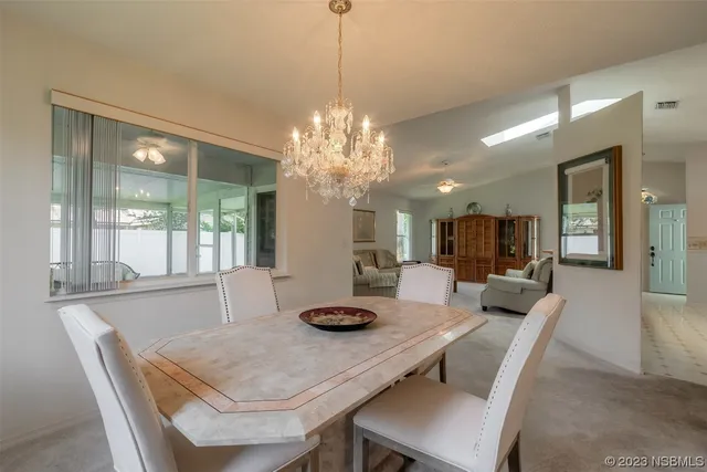 a dining room with furniture and window